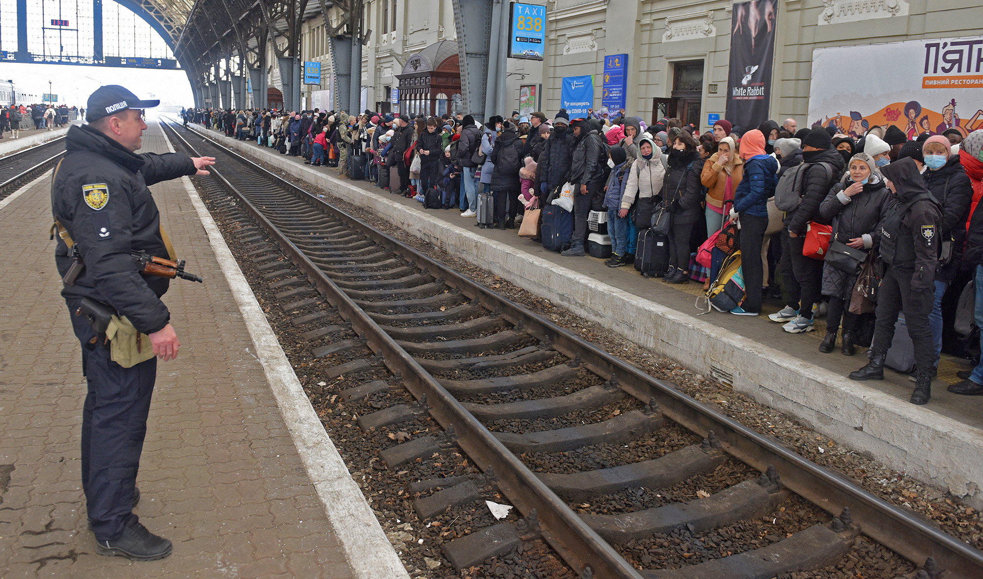 People wait for a train to Poland at the railway station of the western Ukrainian city of Lviv on February 26, 2022. (AFP)