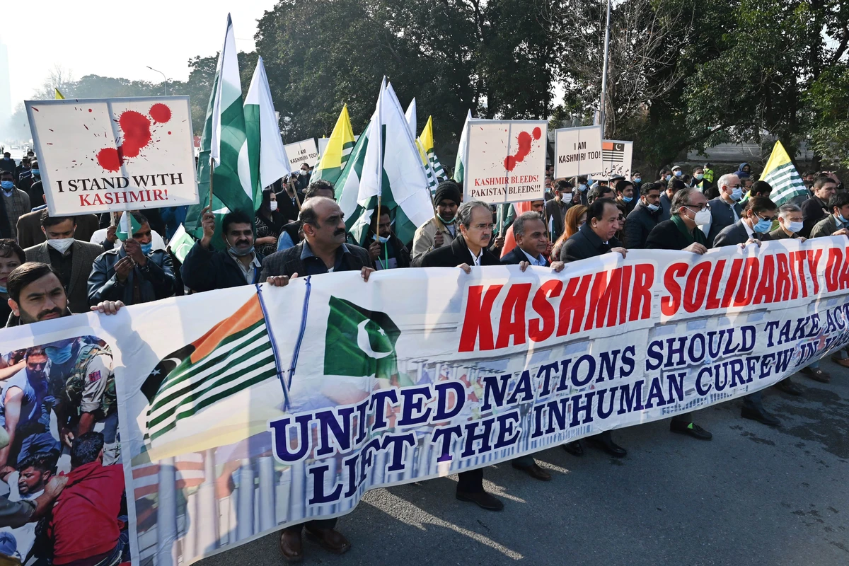 People carry a banner during a rally to mark Kashmir Solidarity Day in Islamabad on February 5, 2022. (AFP)