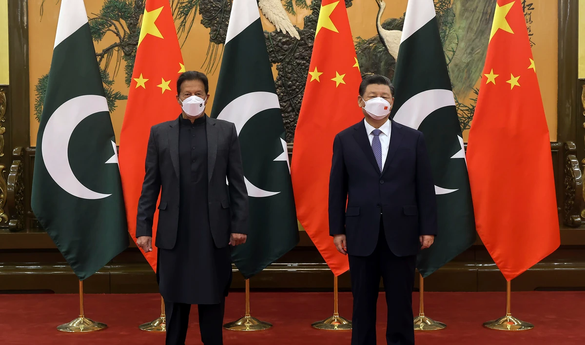 Chinese President Xi Jinping, right, and Pakistan Prime Minister Imran Khan pose for a photo before their bilateral meeting at the Great Hall of the People in Beijing on February 6, 2022. (Xinhua via AP)