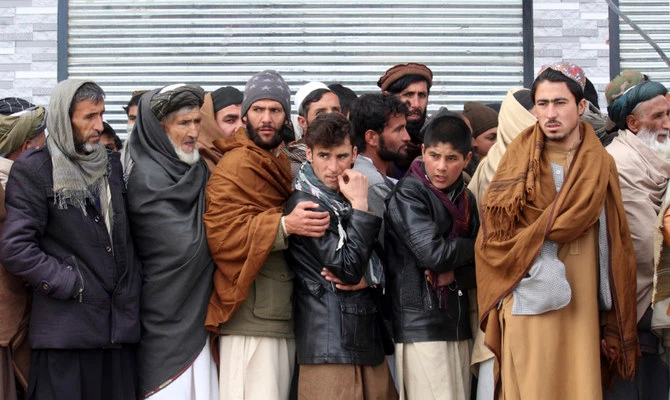 Afghans wait to receive food rations organized by the World Food Program (WFP) in Pul-e-Alam, the capital of Logar province, eastern of Afghanistan, Tuesday, Jan. 18, 2022. (AP)
