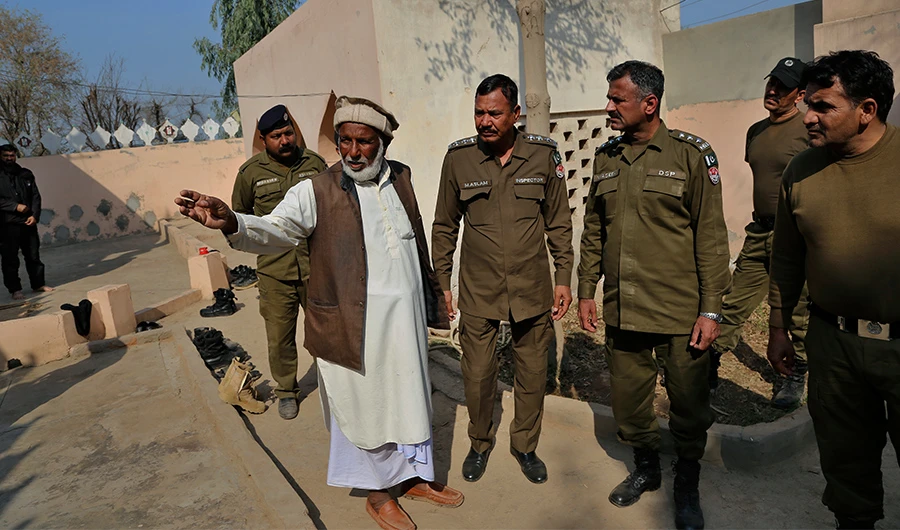 Mian Mohammad Ramzan the mosque custodian briefs police officers regarding the stoning to death of Mushtaq Ahmed by mob for alleged blasphemy in Tulamba, a remote village in the district of Khanewal, Pakistan, Feb. 13, 2022. (AP)