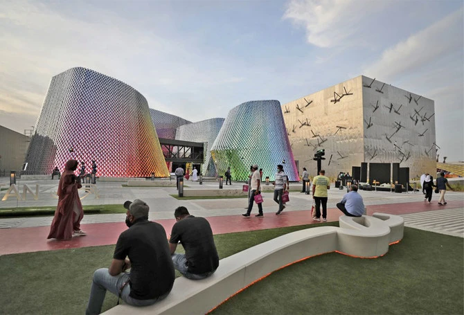 People pass by the Pakistan pavilion, left, and the Bahrain pavilions at the Dubai Expo 2020, in Dubai, United Arab Emirates, on October 3, 2021. (AP)