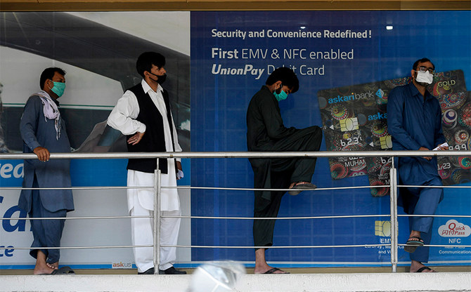 People maintain social distancing in a queue outside a bank in Islamabad on June 8, 2020. (AFP/FILE)