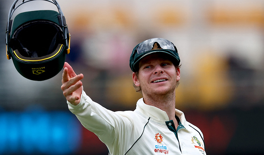 Australia's batsman Steve Smith throws the helmet towards wicketkeeper Tim paine on day two of the fourth cricket Test match between Australia and India at the Gabba in Brisbane on January 16, 2021. (AFP/FILE)