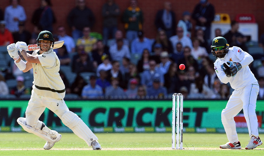 Australia's batsman David Warner (L) plays a shot as Pakistan's wicketkeeper Mohammad Rizwan looks on during the second cricket Test match between Australia and Pakistan in Adelaide on Nov 30, 2019. (AFP/FILE)