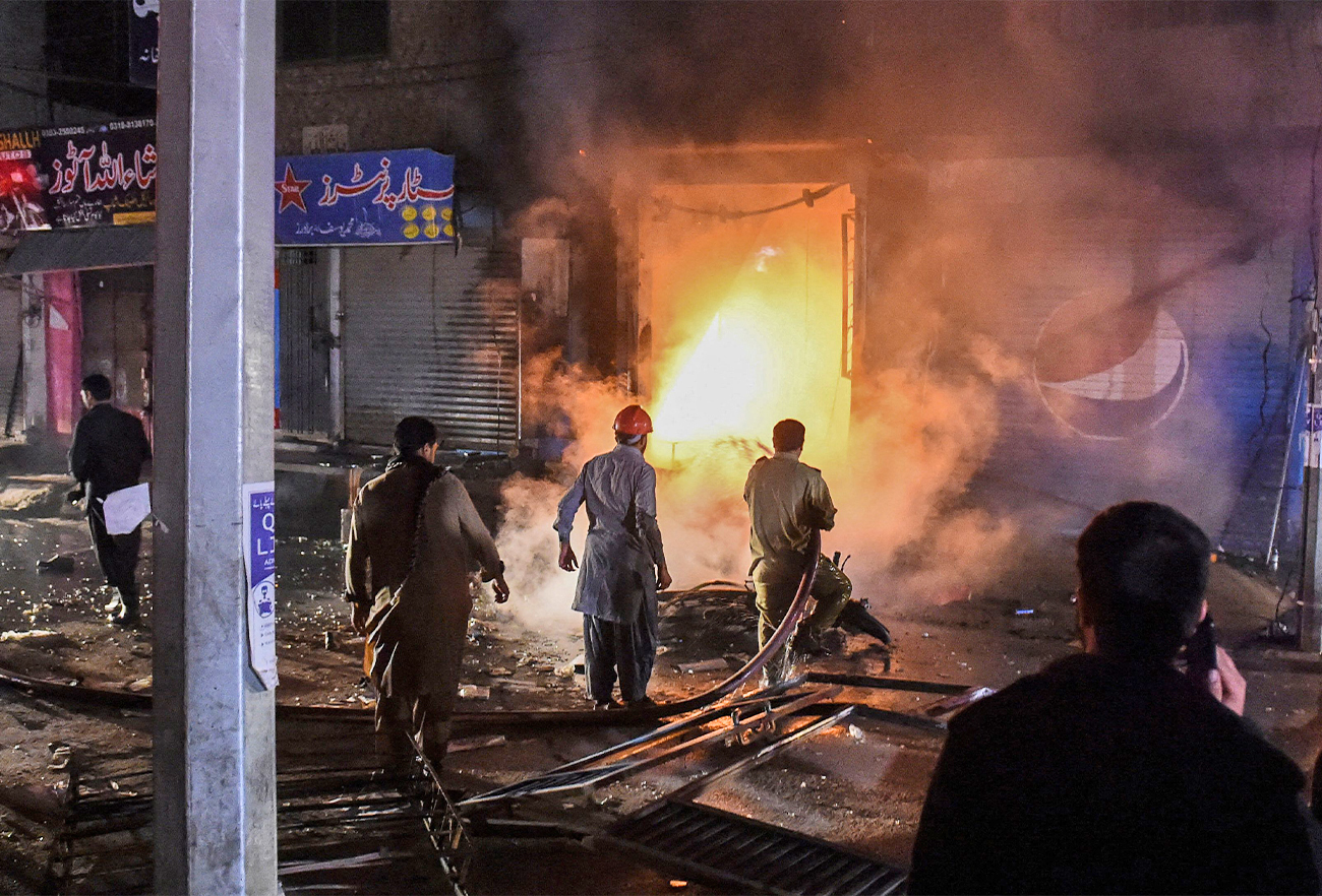 Firefighters try to extinguish fire at the site of an explosion, which killed three people and wounded several others, at a market area in Quetta, Pakistan, on March 2, 2022. (AFP)