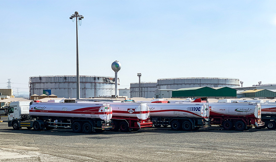 This picture taken November 24, 2020 shows fuel trucks parked near silos at the Saudi Aramco oil facility in Saudi Arabia's Red Sea city of Jeddah. (AFP/FILE)