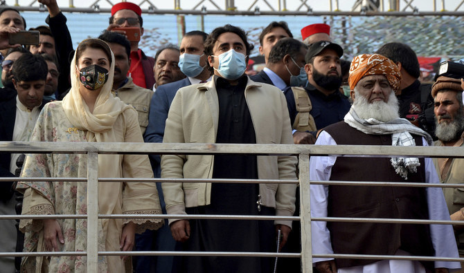 Maulana Fazal-ur-Rehman (R) in front row, Bilawal Bhutto Zardari (C) Maryam Nawaz Sharif (L) leaders of the Pakistan Democratic Movement, an alliance of opposition parties, attend an anti-government rally in Peshawar on Nov. 22, 2020. (AFP/FILE)