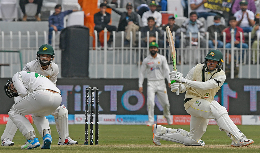 Australia's Usman Khawaja (R) plays a shot as Pakistan's wicketkeeper Mohammad Rizwan (2L) watches in Rawalpindi on March 6, 2022. (AFP)