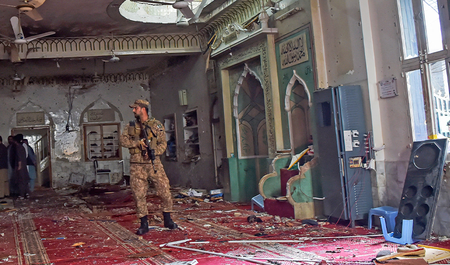 A soldier stands guard inside a mosque after a bomb blast in Peshawar on March 4, 2022. (AFP)