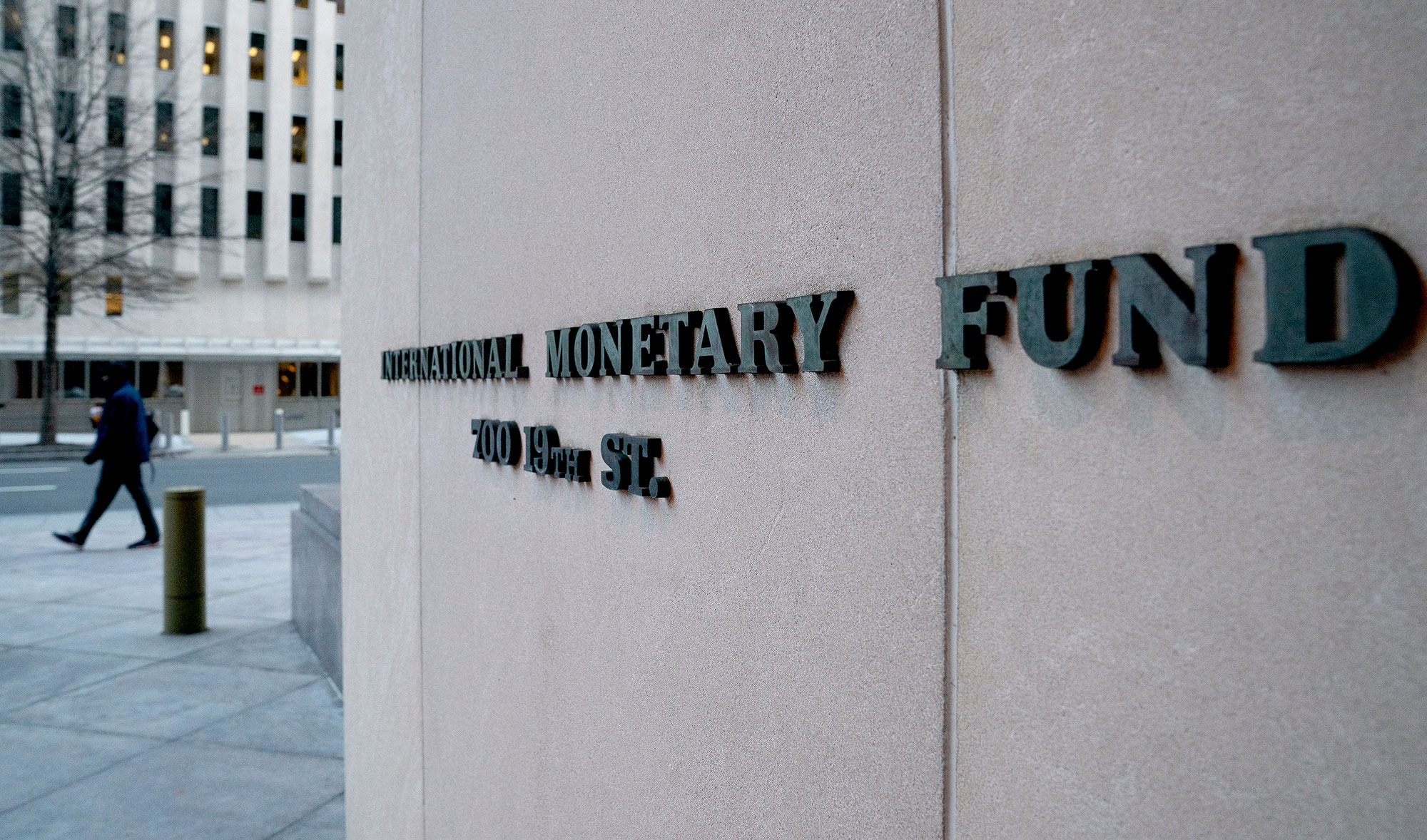 A pedestrian walks past the International Monetary Fund (IMF) headquarters in Washington, DC on January 10, 2022. (AFP/File)