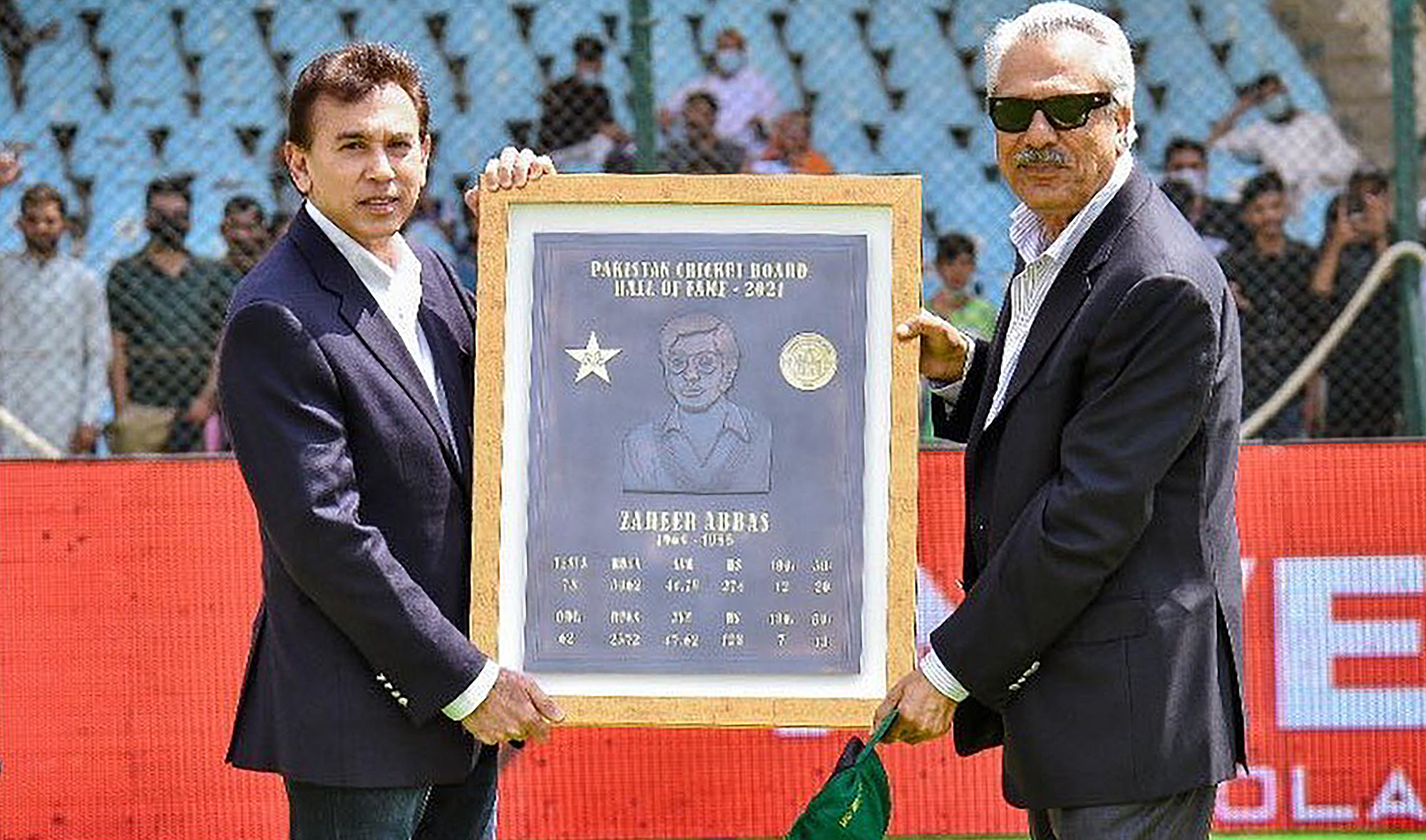 Legend batsman Zaheer Abbas, right, receives a commemorative plaque from Pakistan Cricket Board CEO Faisal Hasnain at the National Stadium in Karachi on March 12, 2022, after being inducted into the PCB Hall of Fame. (Photo courtesy: PCB)