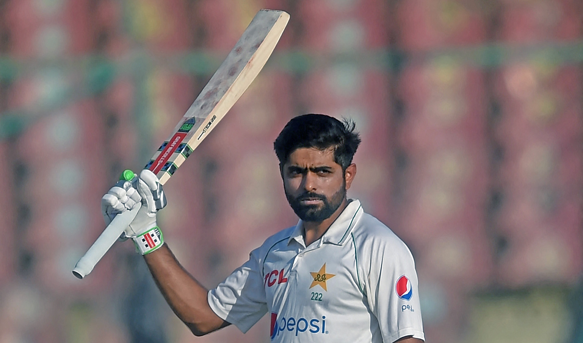 Pakistan's captain Babar Azam celebrates after scoring a century during the fourth day of the second Test cricket against Australia at the National Cricket Stadium in Karachi on March 15, 2022. (AFP)