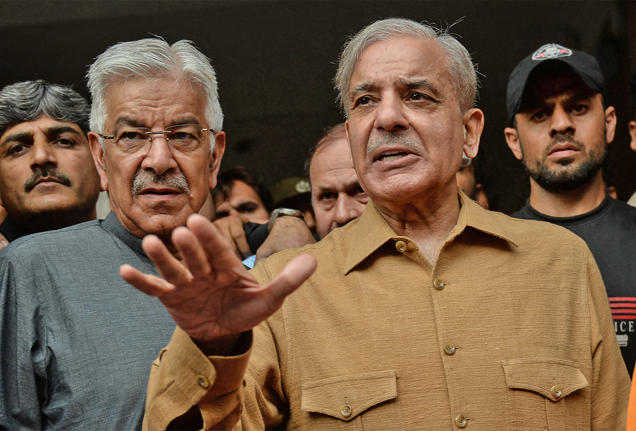 Pakistani leader of the opposition in the lower house of parliament, Shehbaz Sharif (right), talks with media representatives in Lahore, Pakistan, on October 25, 2019. (AFP/File)