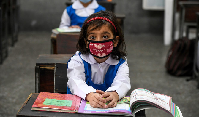 Children wearing facemasks attend a class at a school in Islamabad on September 30, 2020. (AFP/ File)