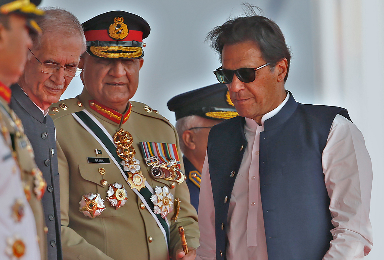 Pakistan's Prime Minister Imran Khan, right, Army Chief General Qamar Javed Bajwa, center, and Defense Minister Pervez Khattaq attend a military parade to mark Pakistan National Day in Islamabad, Pakistan, on March 23, 2022. (AP)