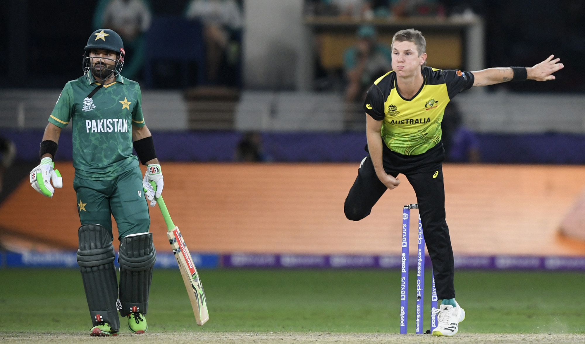 Australia's Adam Zampa, right, bowls next to Pakistan's Mohammad Rizwan during the ICC men’s Twenty20 World Cup semi-final match between Australia and Pakistan at the Dubai International Cricket Stadium in Dubai on November 11, 2021. (AFP)