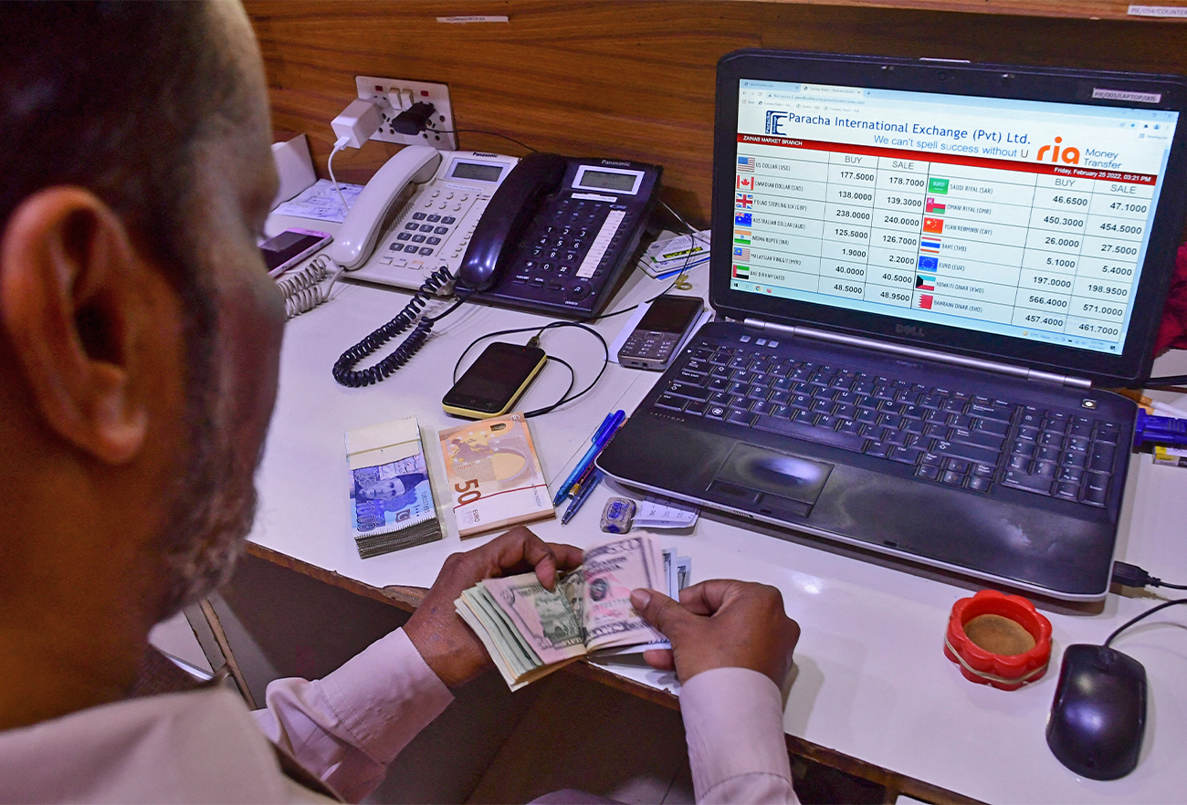 A foreign currency dealer counts US dollar bills at a shop in Karachi, Pakistan, on February 25, 2022. (AFP/File)