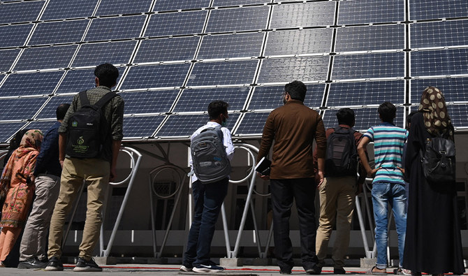 Students look at the facade of a building made with solar panels producing some 148 Kilowatts during its inauguration at the University of Engineering and Technology in Lahore on October 12, 2020. (AFP/FILE)