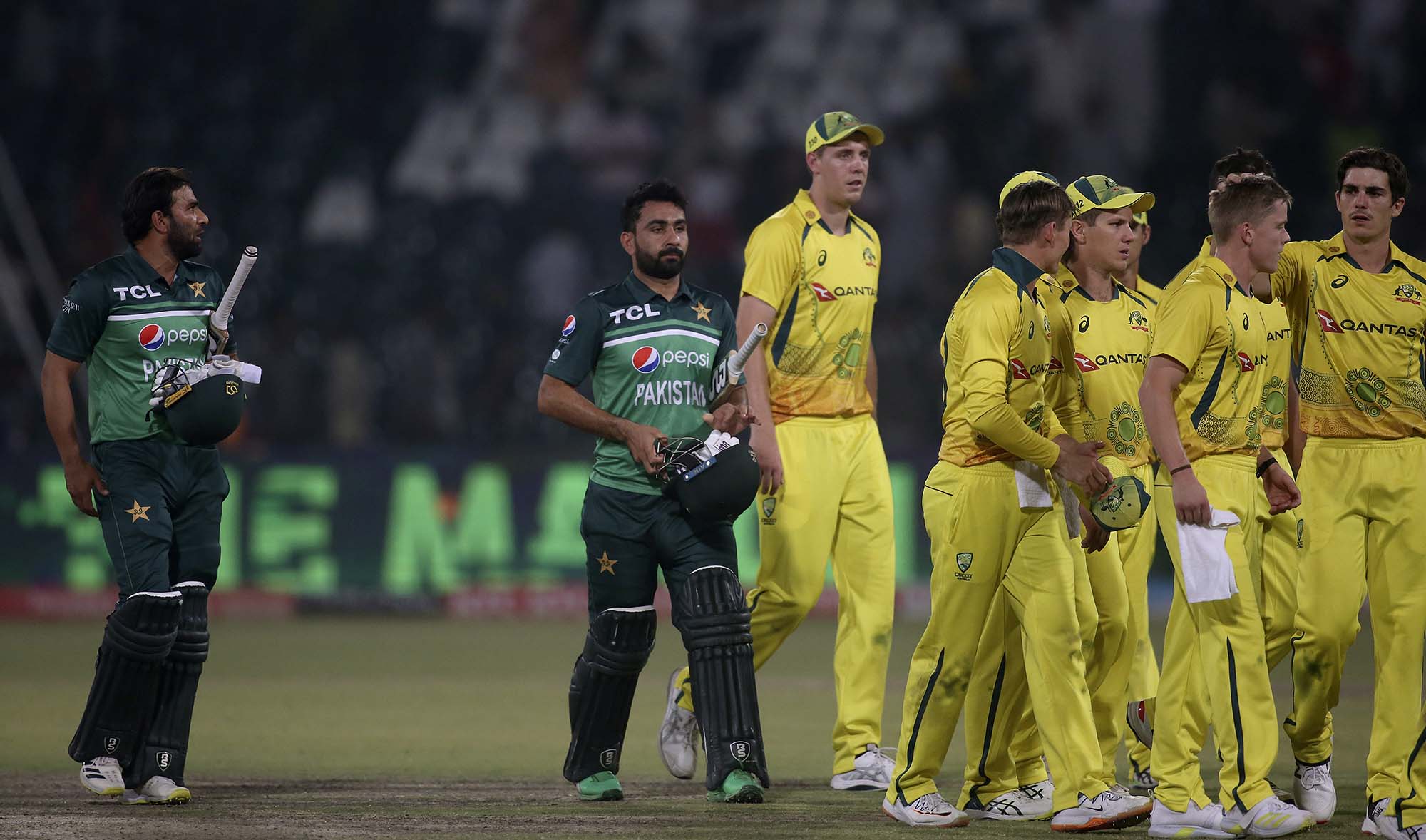 Pakistani and Australian players leaving the ground on end of the second one day international cricket match between Pakistan and Australia at Gaddafi Stadium in Lahore, Pakistan, on March 31, 2022. (AP)