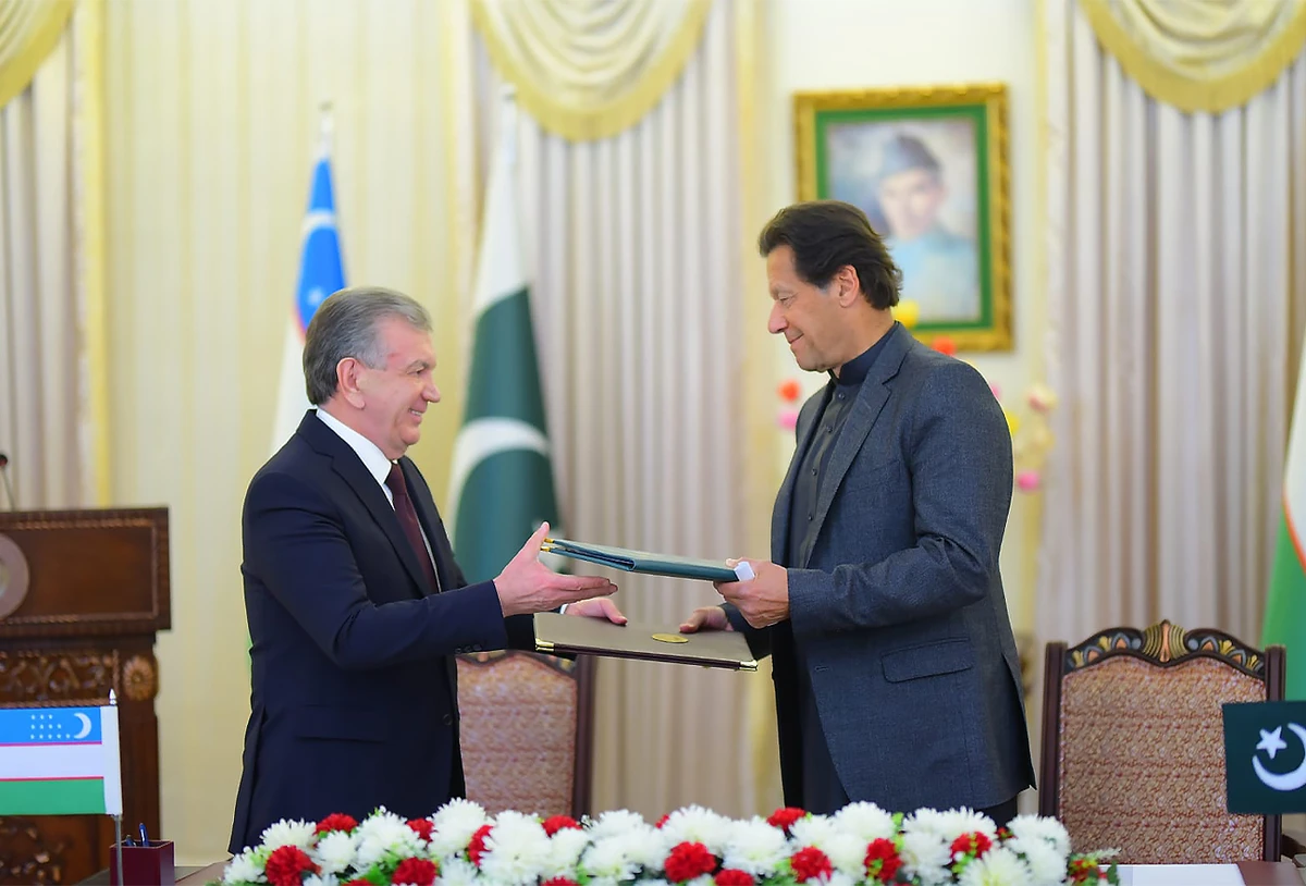 Pakistan's Prime Minister Imran Khan (right) and President of Uzbekistan Shavkat Mirziyoyev sign a joint declaration in Islamabad, Pakistan, on March 3, 2022. (Government of Pakistan/Twitter)