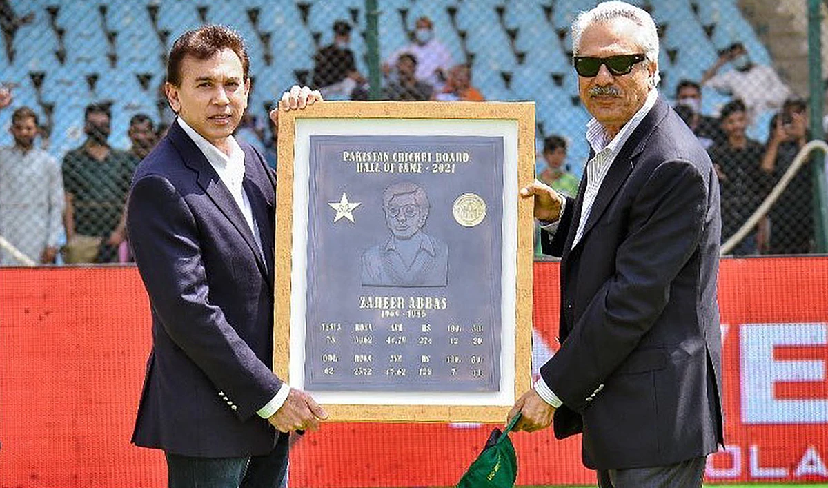 Legend batsman Zaheer Abbas, right, receives a commemorative plaque from Pakistan Cricket Board CEO Faisal Hasnain at the National Stadium in Karachi on March 12, 2022, after being inducted into the PCB Hall of Fame. (Photo courtesy: PCB)