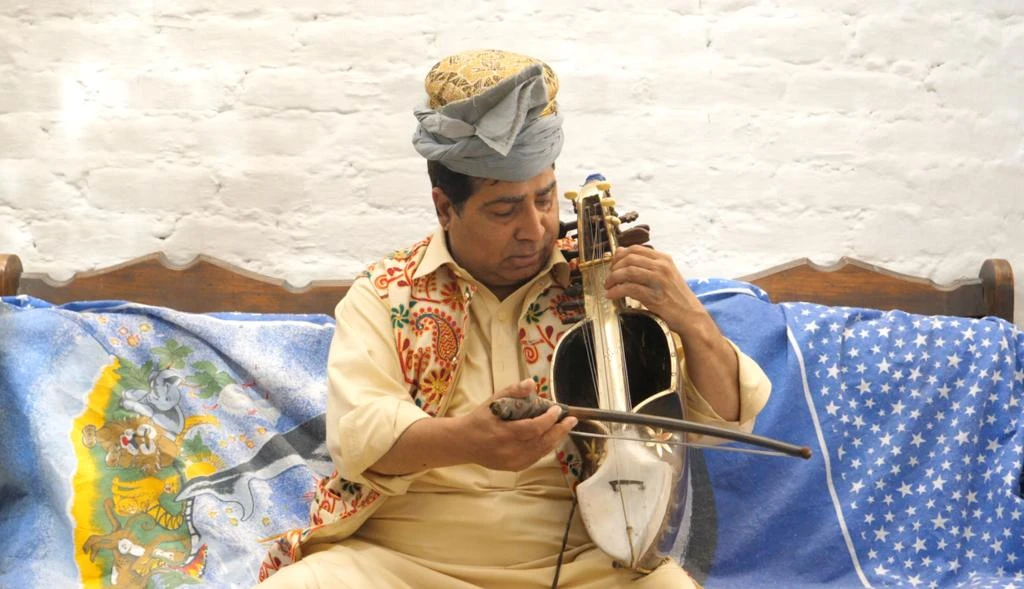 Ejaz Sarhadi, Pakistan's last master of sarinda, plays the instrument at his home in Peshawar, Pakistan on March 17, 2022. (AN photo)