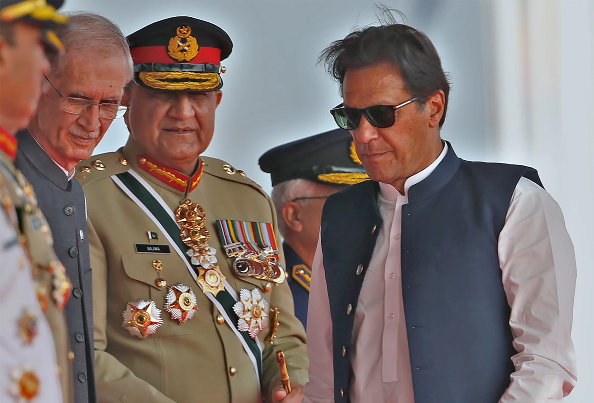 Pakistan's Prime Minister Imran Khan, right, Army Chief General Qamar Javed Bajwa, center, and Defense Minister Pervez Khattaq attend a military parade to mark Pakistan National Day in Islamabad, Pakistan, on March 23, 2022. (AP)
