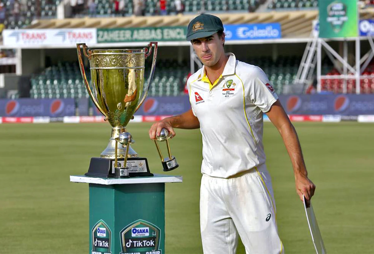 Australia's skipper Pat Cummins poses for photograph with trophy after winning the third test and series against Pakistan at the Gaddafi Stadium in Lahore, Pakistan, on March 25, 2022. (AP)
