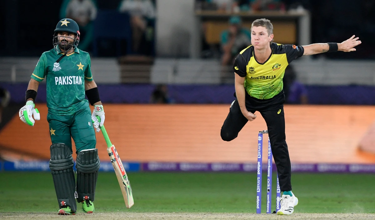 Australia's Adam Zampa, right, bowls next to Pakistan's Mohammad Rizwan during the ICC men’s Twenty20 World Cup semi-final match between Australia and Pakistan at the Dubai International Cricket Stadium in Dubai on November 11, 2021. (AFP)
