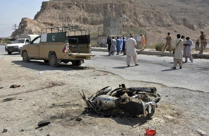 Security officials examine the site of suicide bombing in a checkpoint on the outskirts of Quetta, Pakistan, Sunday, Sept. 5, 2021. (AFP)
