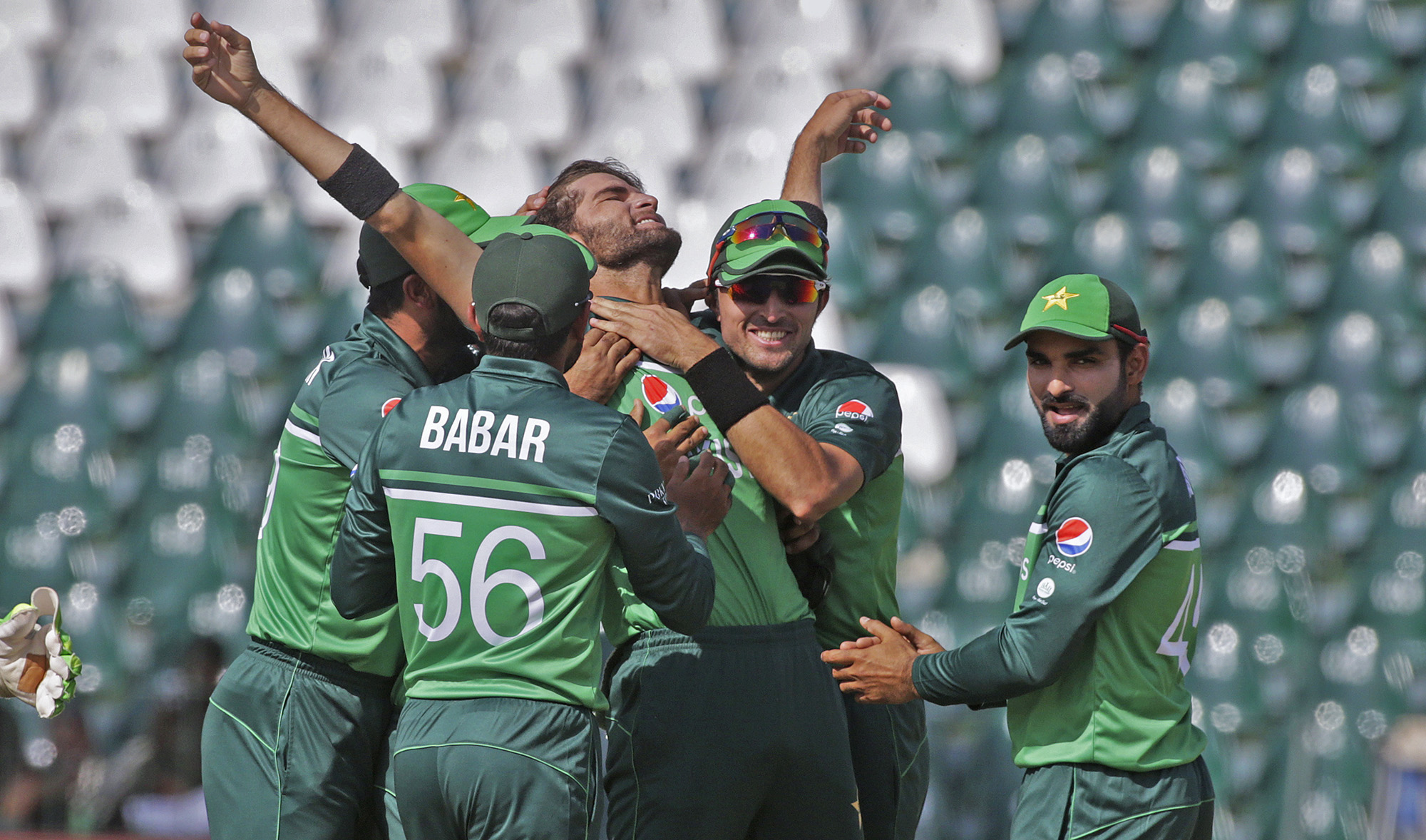 Pakistan's Shaheen Shah Afridi, center, and teammates celebrate after the dismissal of Australia's Travis Head during the third one day international cricket match at Gaddafi Stadium in Lahore, Pakistan on April 2, 2022. (AP)
