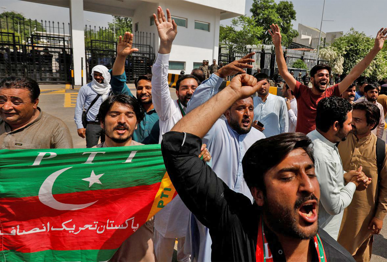 Supporters of the Pakistan Tehreek-e-Insaf (PTI) political party, chant slogans in support of Pakistani Prime Minister Imran Khan, outside parliament building Islamabad, Pakistan, on April 3, 2022. (REUTERS)