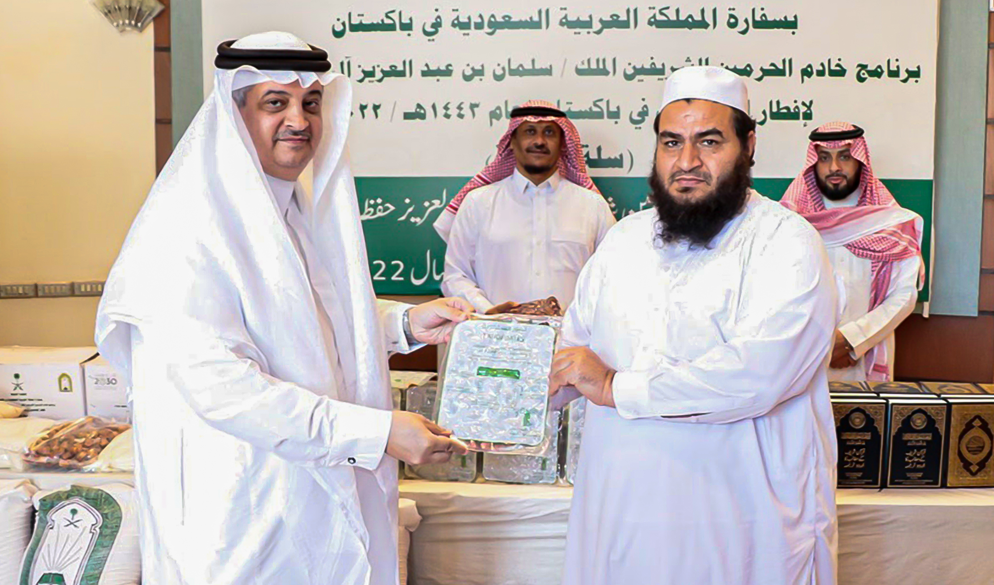 Saudi Arabia's Ambassador to Pakistan, Nawaf bin Saeed Al-Malki, left, distributing Ramadan food baskets in Islamabad on April 6, 2022. (Photo courtesy: @KSAembassyPK/Twitter)