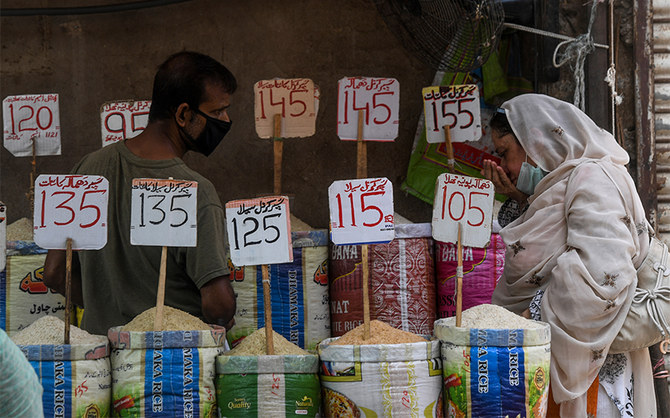 A woman checks the smell of rice at a market in Karachi, Pakistan, on June 10, 2020. (AFP/File)