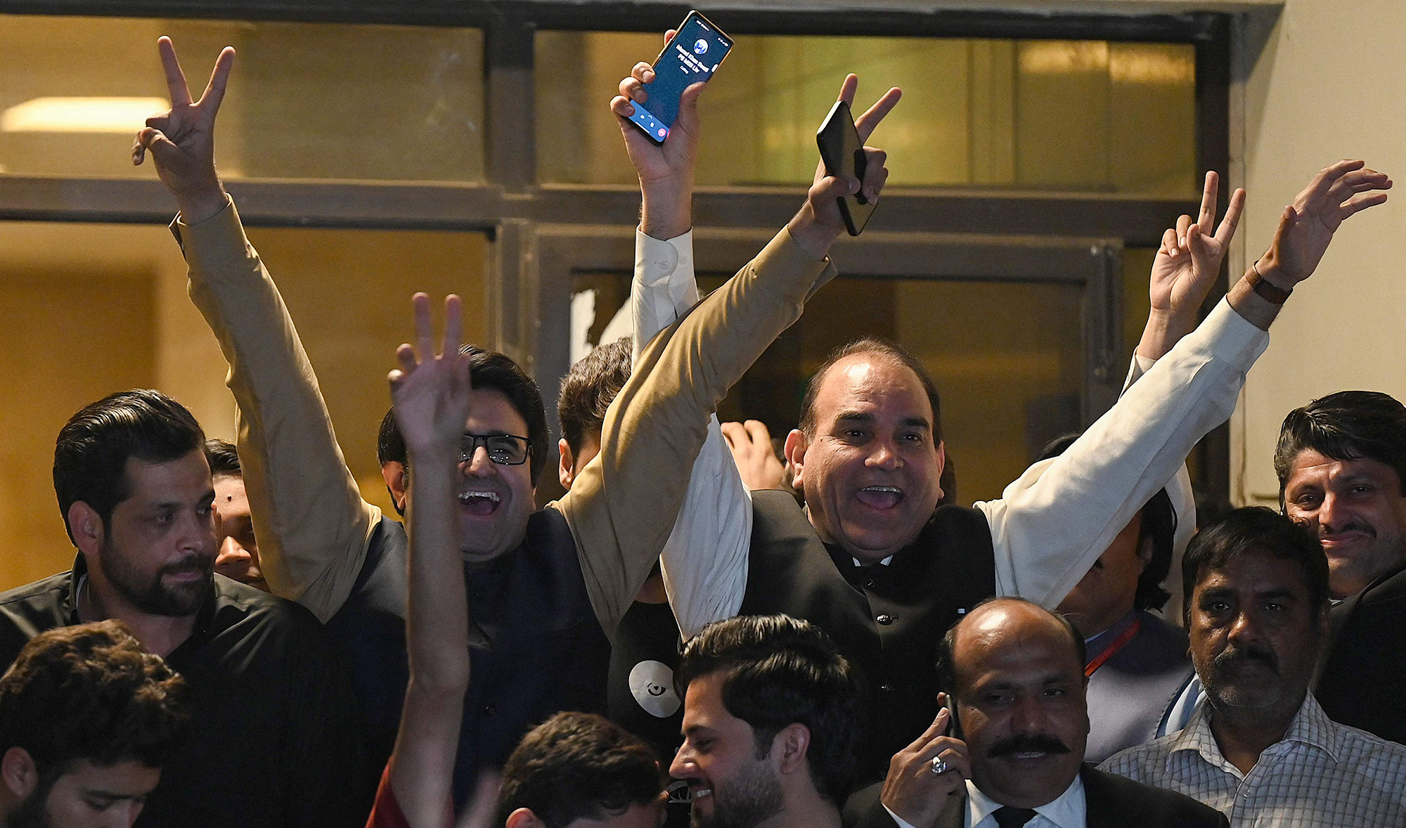 Opposition supporters celebrate outside the Supreme Court building after a court verdict in Islamabad on April 7, 2022. (AFP)