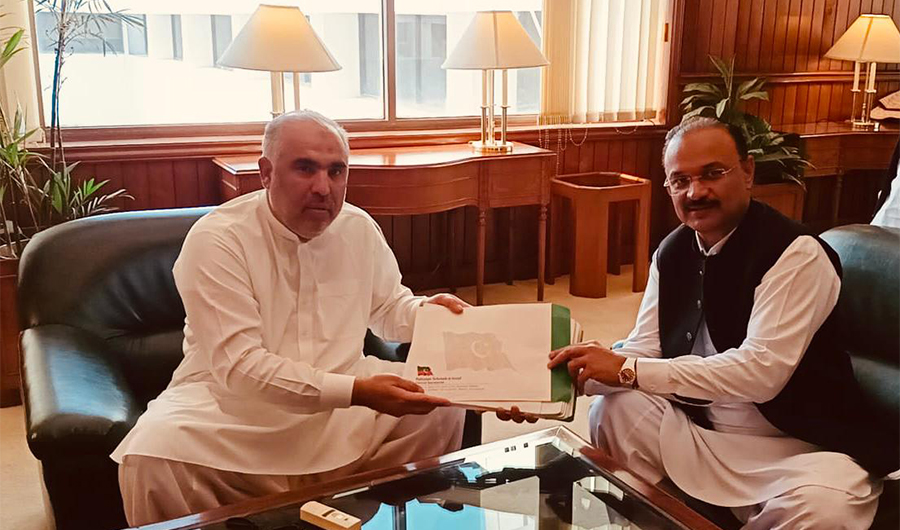 Pakistan National Assembly Speaker Asad Qaiser, left, receives on April 9, 2022 a reference from the ruling Pakistan Tehreek-e-Insaf (PTI) party against 20 lawmakers who abandoned its ranks ahead of a no-trust vote against Prime Minister Imran Khan. (National Assembly)