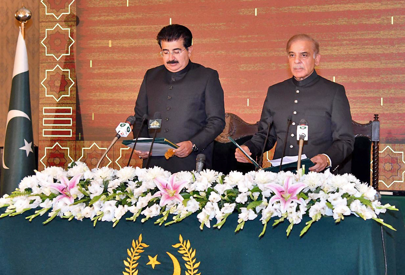 The picture taken on April 11, 2022, shows Chairman Senate Muhammad Sadiq Sanjrani (L) administering oath to Shehbaz Sharif (R) as Prime Minister of Pakistan at the President House in Islamabad, Pakistan. (PID)