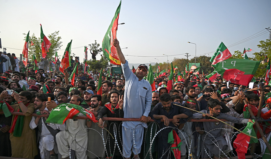 Supporters of ruling Pakistan Tehreek-e-Insaf (PTI) party attend a rally being addressed by Pakistan's Prime Minister Imran Khan, in Islamabad on March 27, 2022. (AFP)