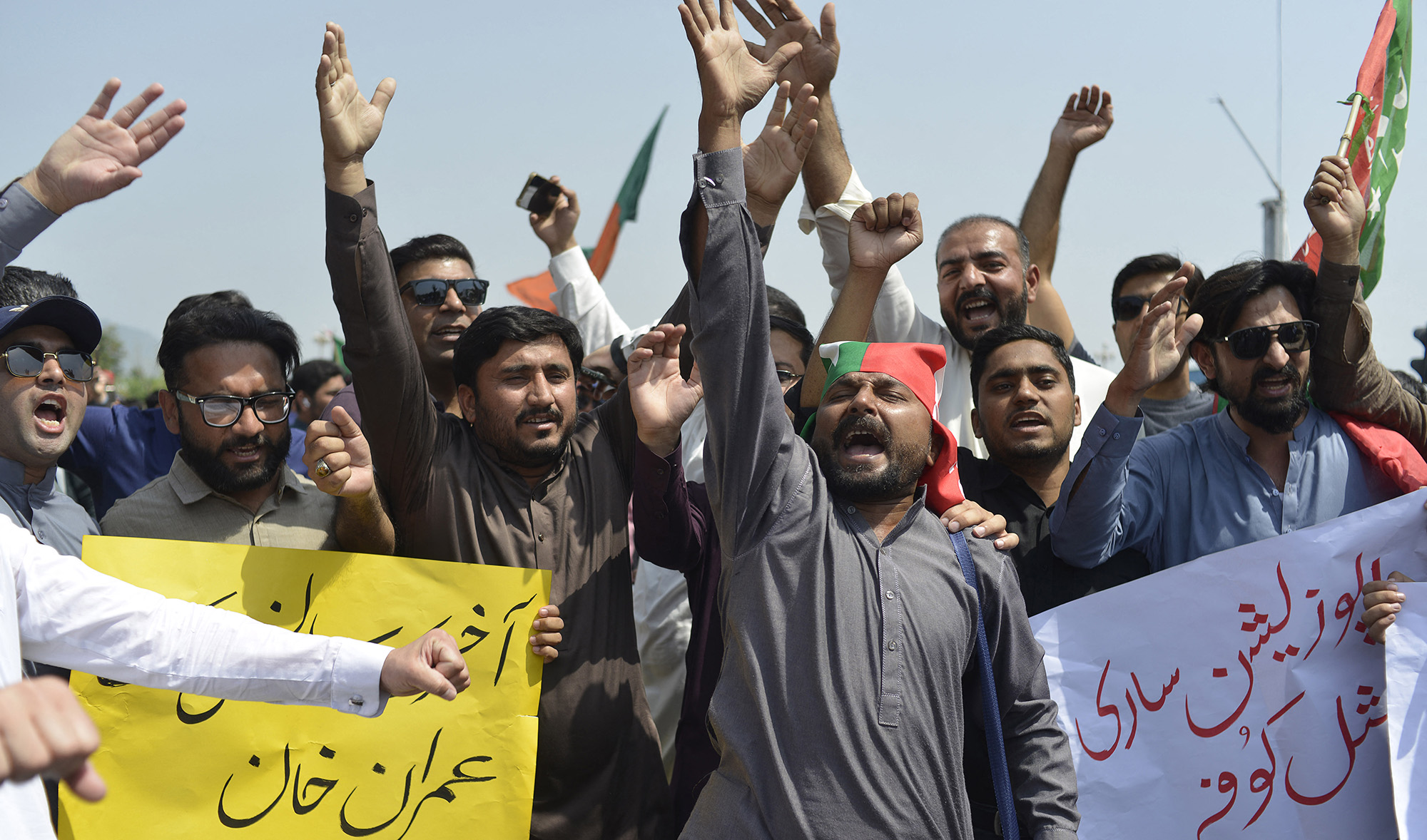 Activists of ruling Pakistan Tehreek-e-Insaf (PTI) shout slogans during a protest in front of the National Assembly in Islamabad on April 3, 2022. (AFP/File)