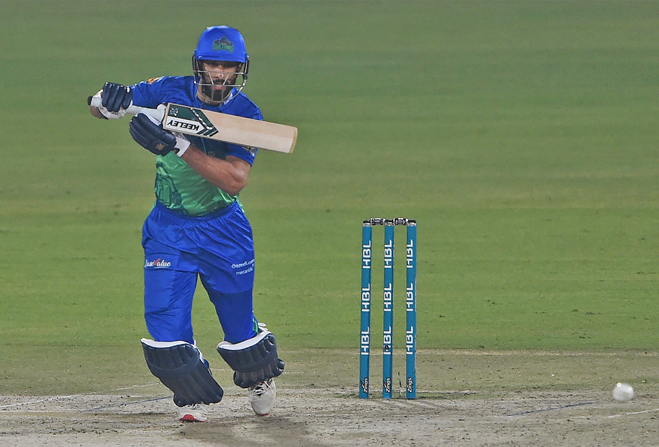 Multan Sultans' Shan Masood (R) plays a shot during the Pakistan Super League T20 cricket match at the National Cricket Stadium in Karachi on January 27, 2022. (AFP/File)