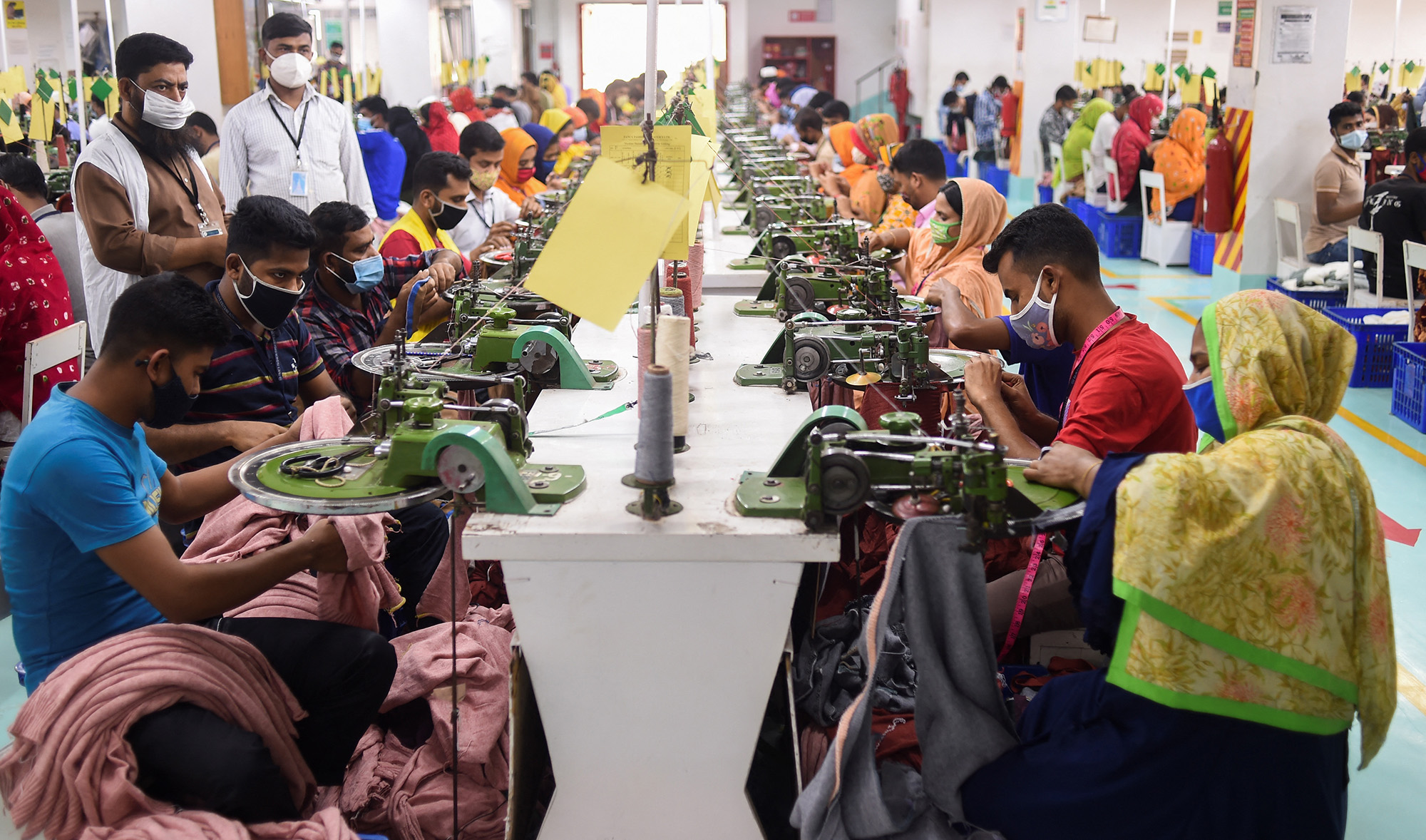 In this picture taken on March 15, 2021, people work in a garment factory in Gazipur. (AFP/File)