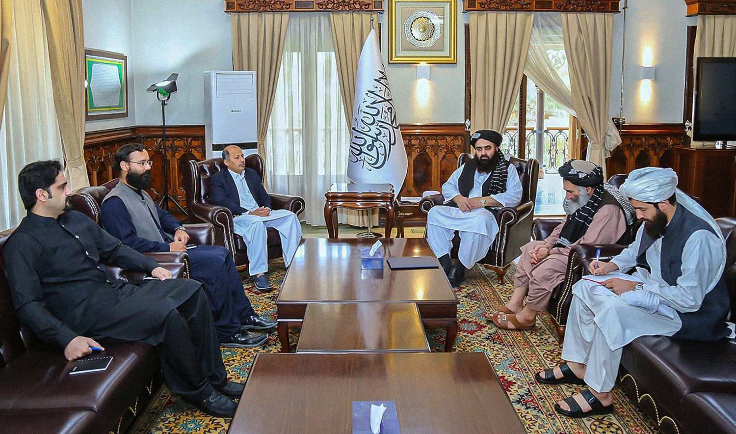 Afghanistan’s foreign minister Mawlawi Amir Khan Muttaqi, center right, receives Pakistani ambassador to Afghanistan Mansoor Khan, center left, at his office in Kabul on April 16, 2022. (Photo courtesy: @MoFA_Afg/Twitter)