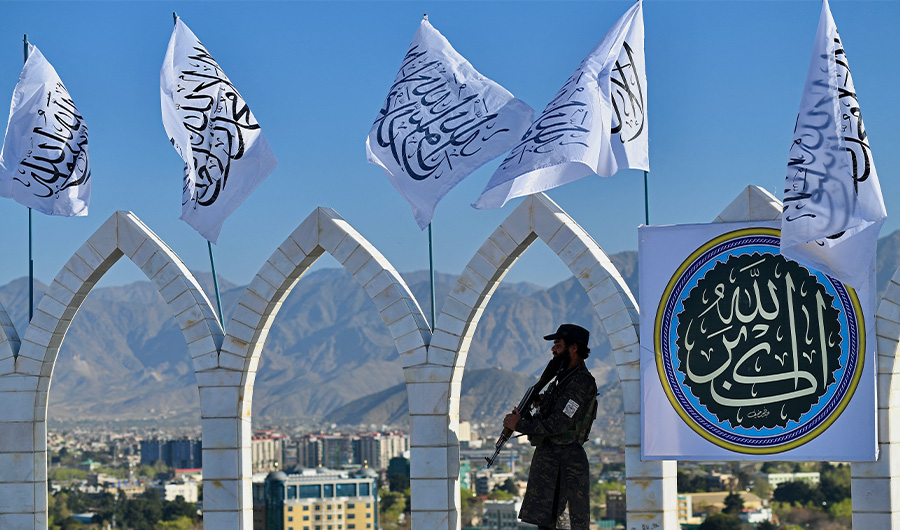 A Taliban fighter stands guard at the venue for a flag hoisting ceremony of the Taliban flag on the Wazir Akbar Khan hill in Kabul on March 31, 2022. (AFP)