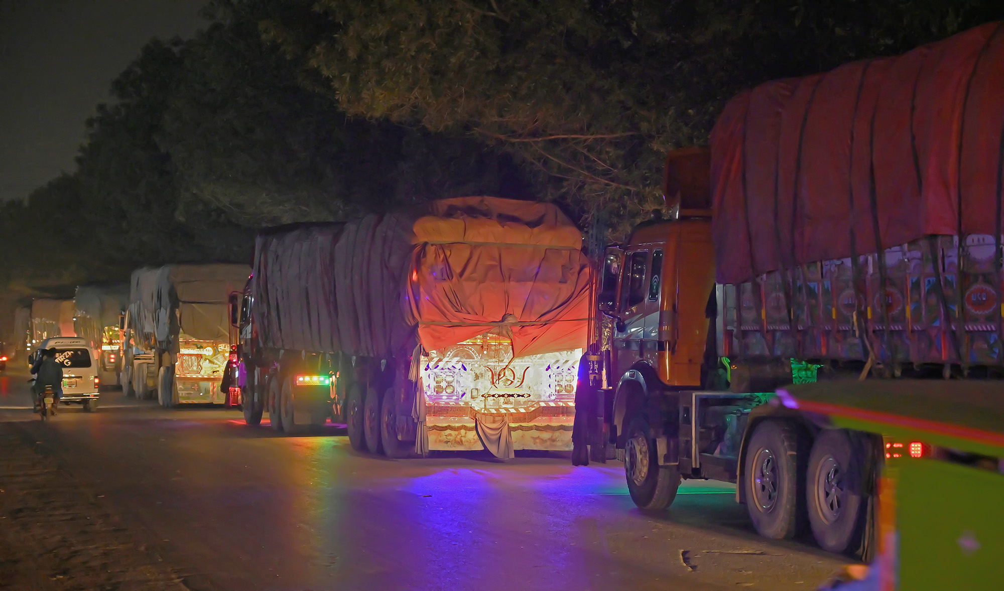 This photograph taken February 23, 2022 shows Afghan trucks carrying wheat on the road to Lahore, after crossing the Pakistan-India Wagah border. (AFP/File)