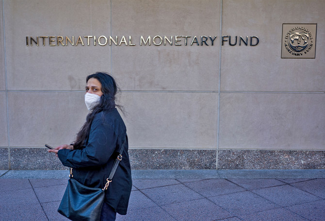 A woman walks past the International Monetary Fund (IMF) headquarters building in Washington, U.S., on March 11, 2022. (AFP/File)