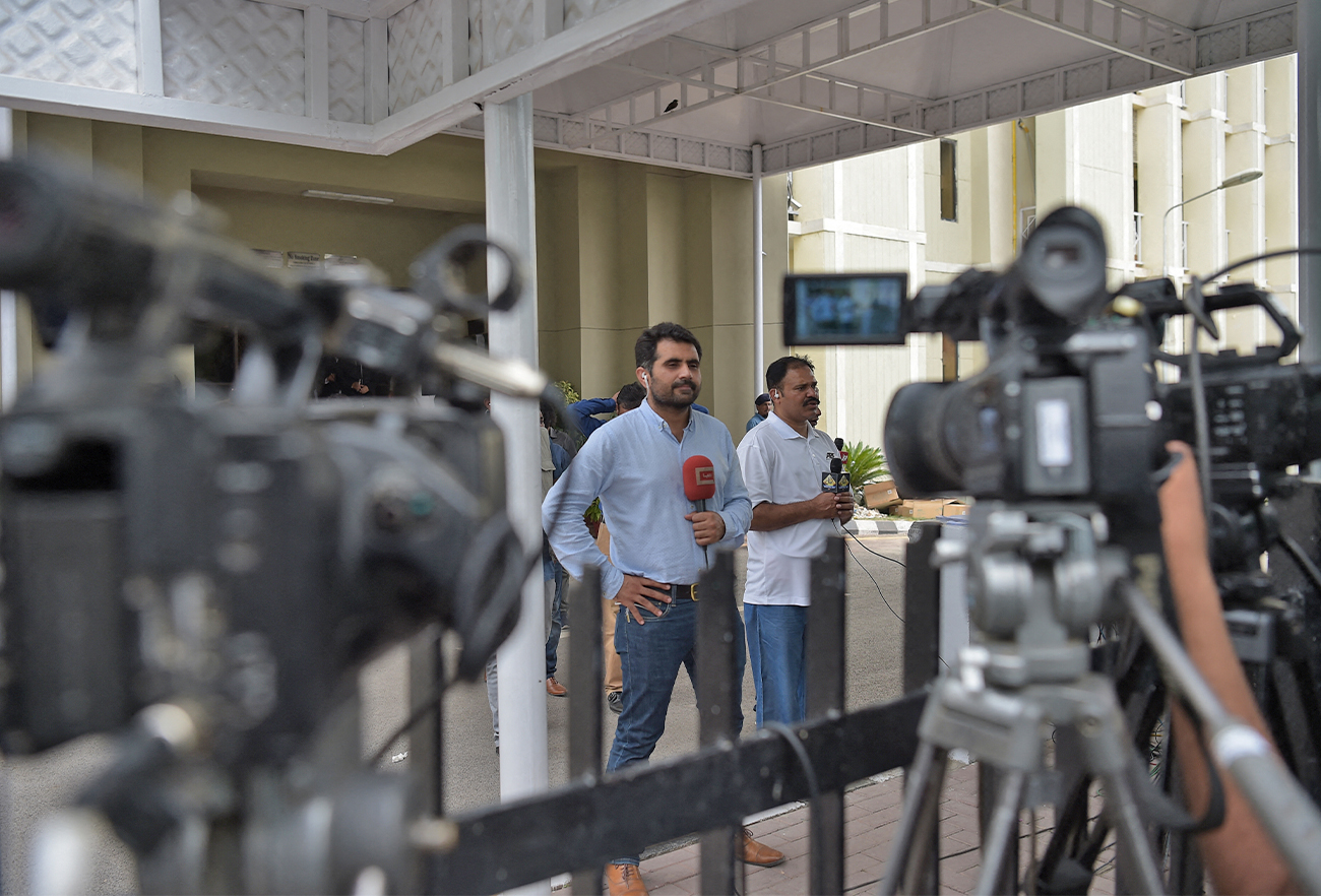 In this picture taken on June 28, 2018, Pakistani journalists broadcast live news from the Supreme Court in Islamabad. (AFP/File)