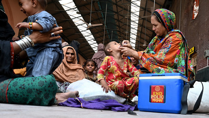 A Pakistani health worker administers polio drops to a child at a railway station during a polio vaccination campaign in Lahore on Aug. 27, 2019. (AFP/File)