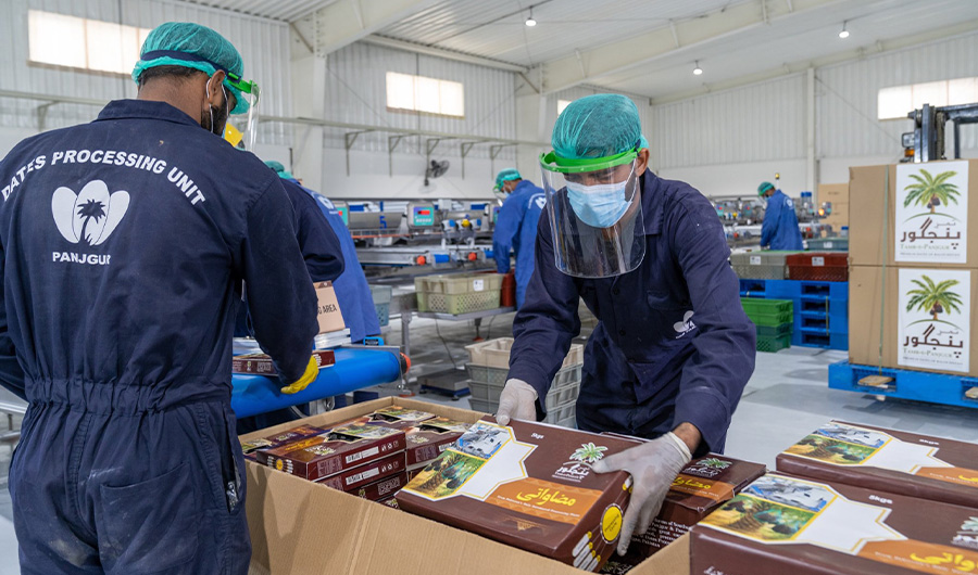 Workers process Pakistan's famous Panjgur dates in a UAE-sponsored dates processing facility in Panjgur, Pakistan on April 24, 2022. (@uaeembassyisb/Twitter)