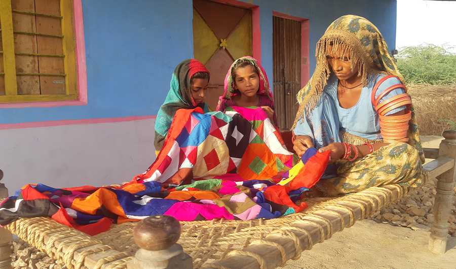 Pummy Kohli stitches a cloth at her new house build under the Low-Cost Houses program in Tando Bago area, Badin district of Sindh province, southern Pakistan on April 18, 2022. (AN Photo/Zulfiqar Kunbhar)